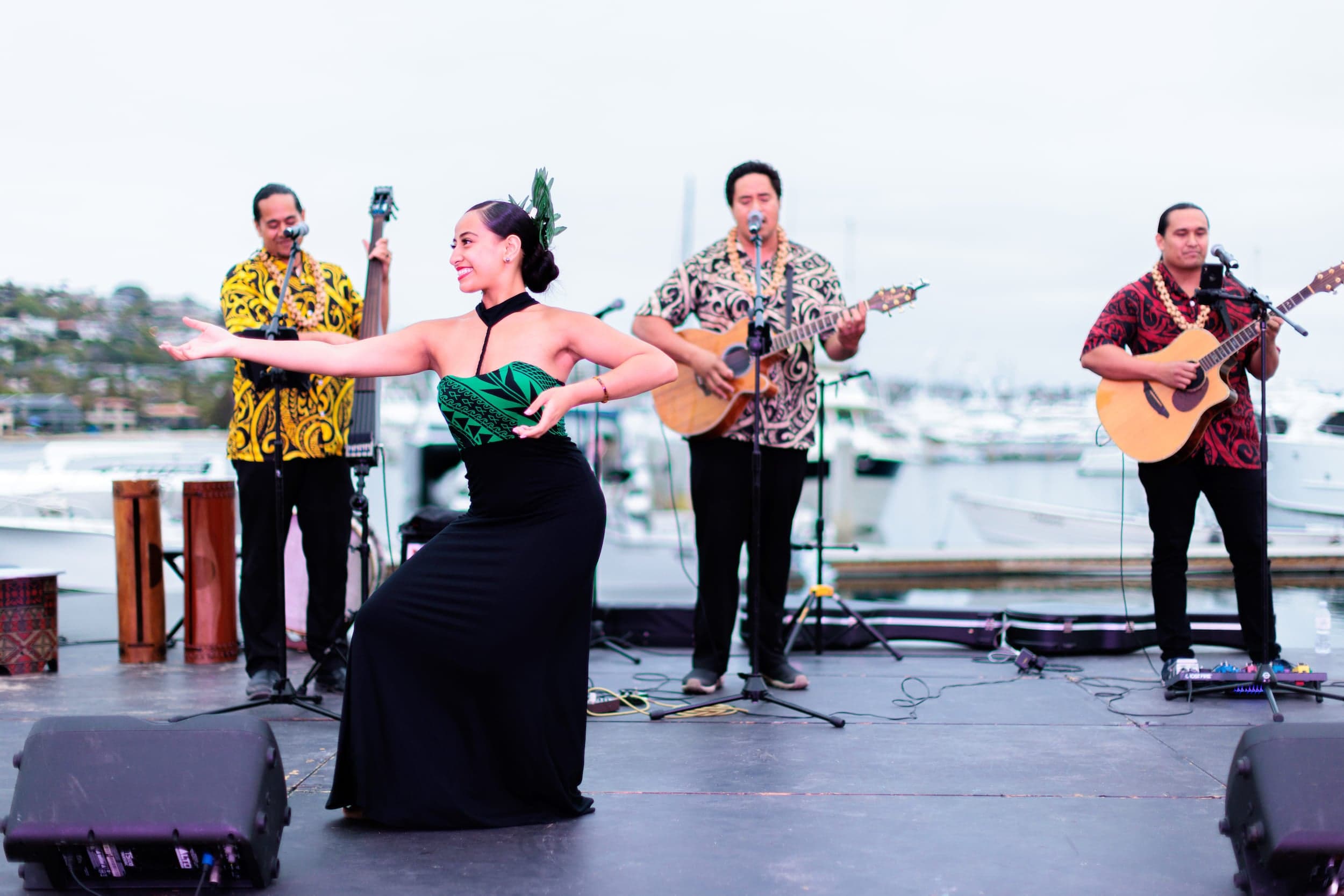 A band playing outside with a female dancer