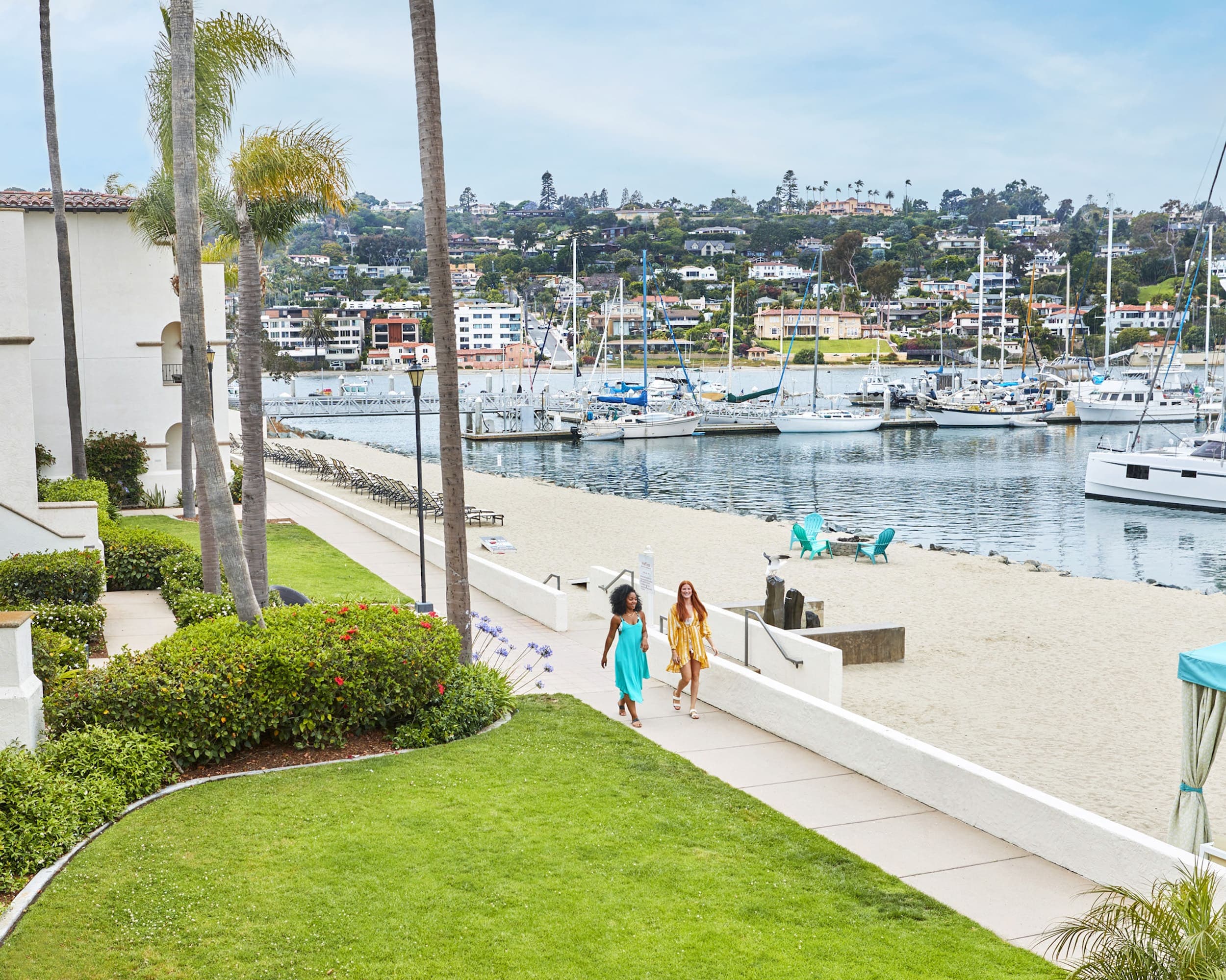 Two people walking down a sidewalk outside Kona Kai