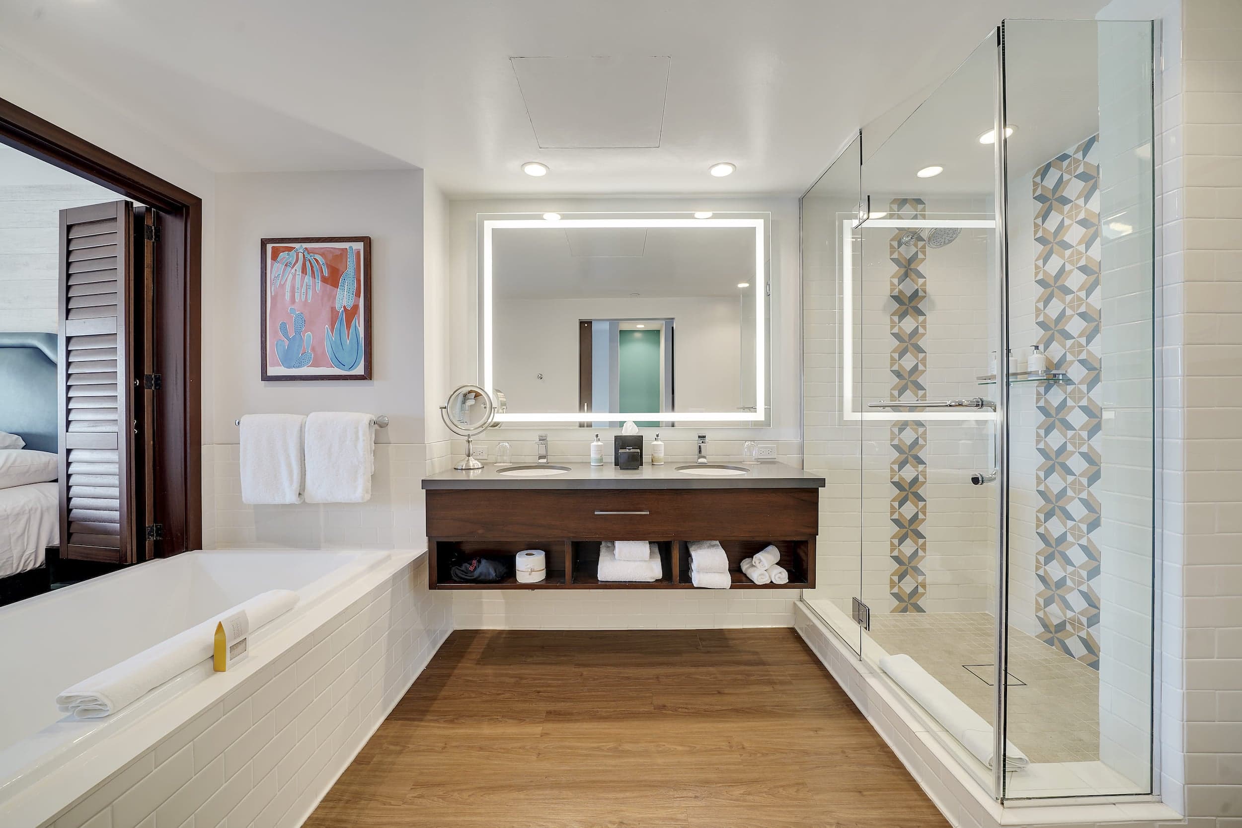 A beautiful and bright bathroom with 2 sinks, a large walk-in shower with a separate tub in a suite at Kona Kai