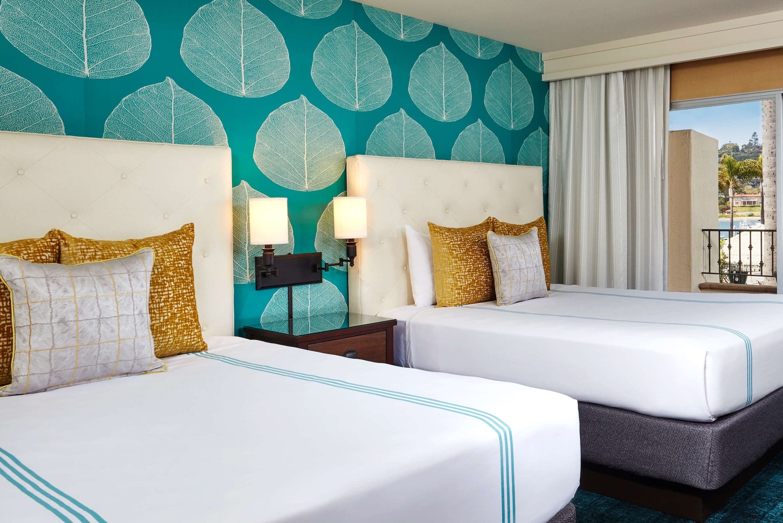 A deluxe 2 queen room at Kona Kai with a ground level patio