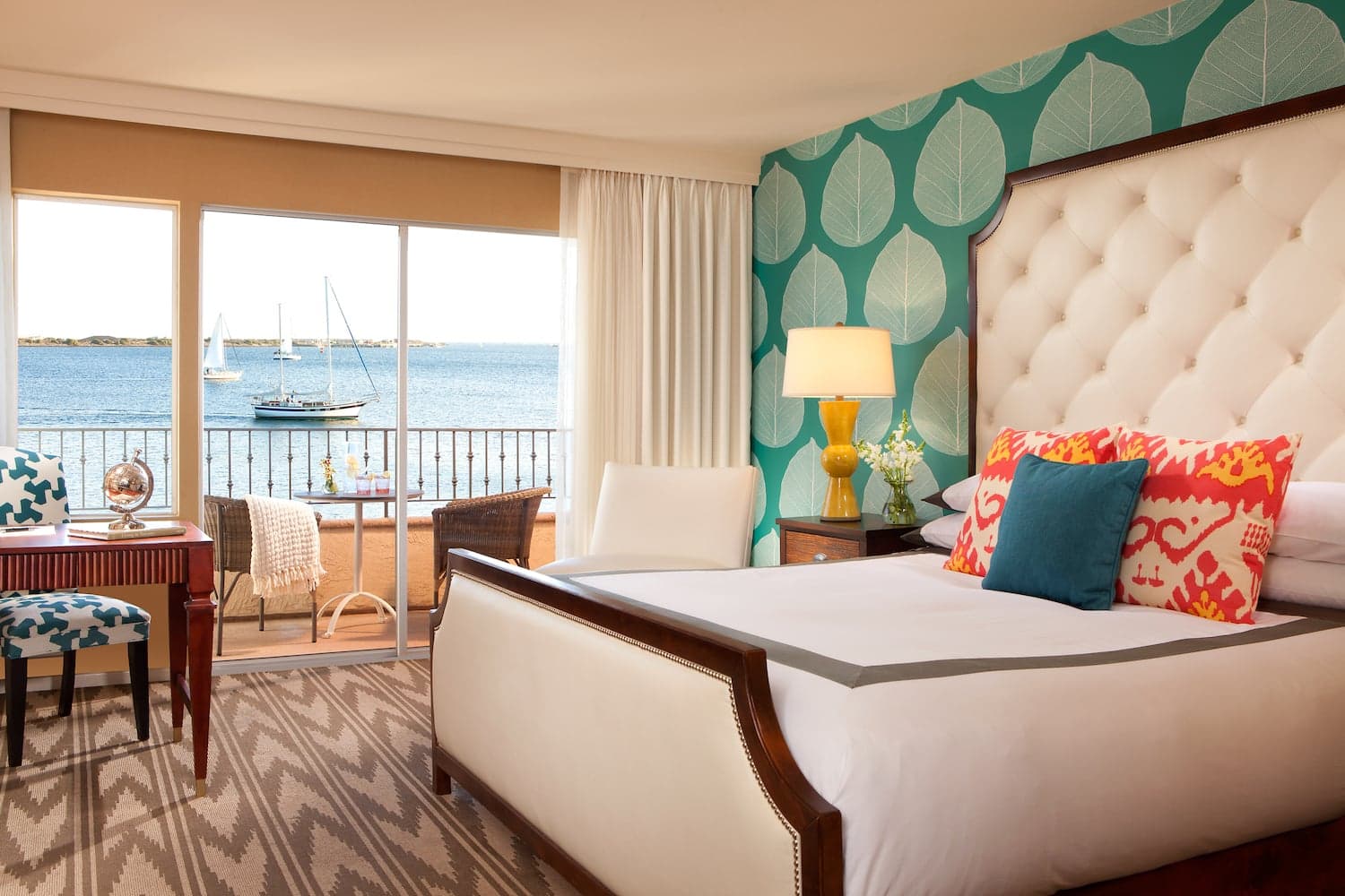 A king bed with a view of the water at Kona Kai