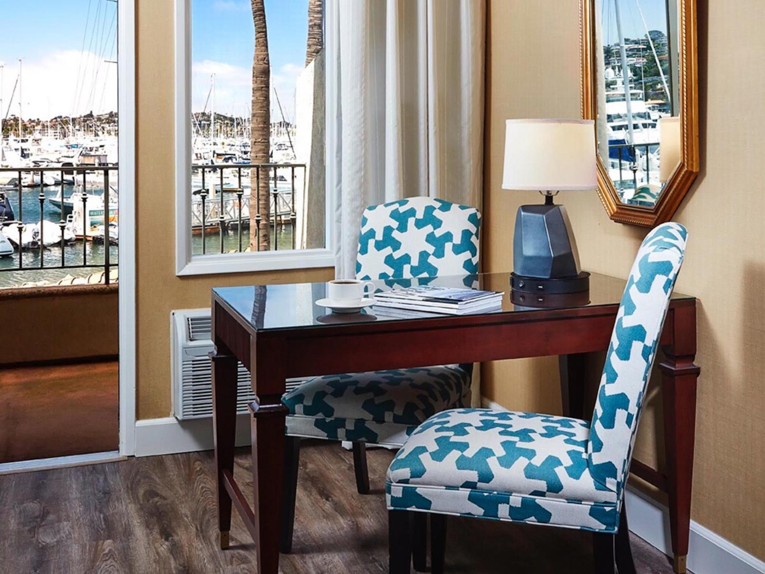 A desk and view of the marina in a room at Kona Kai