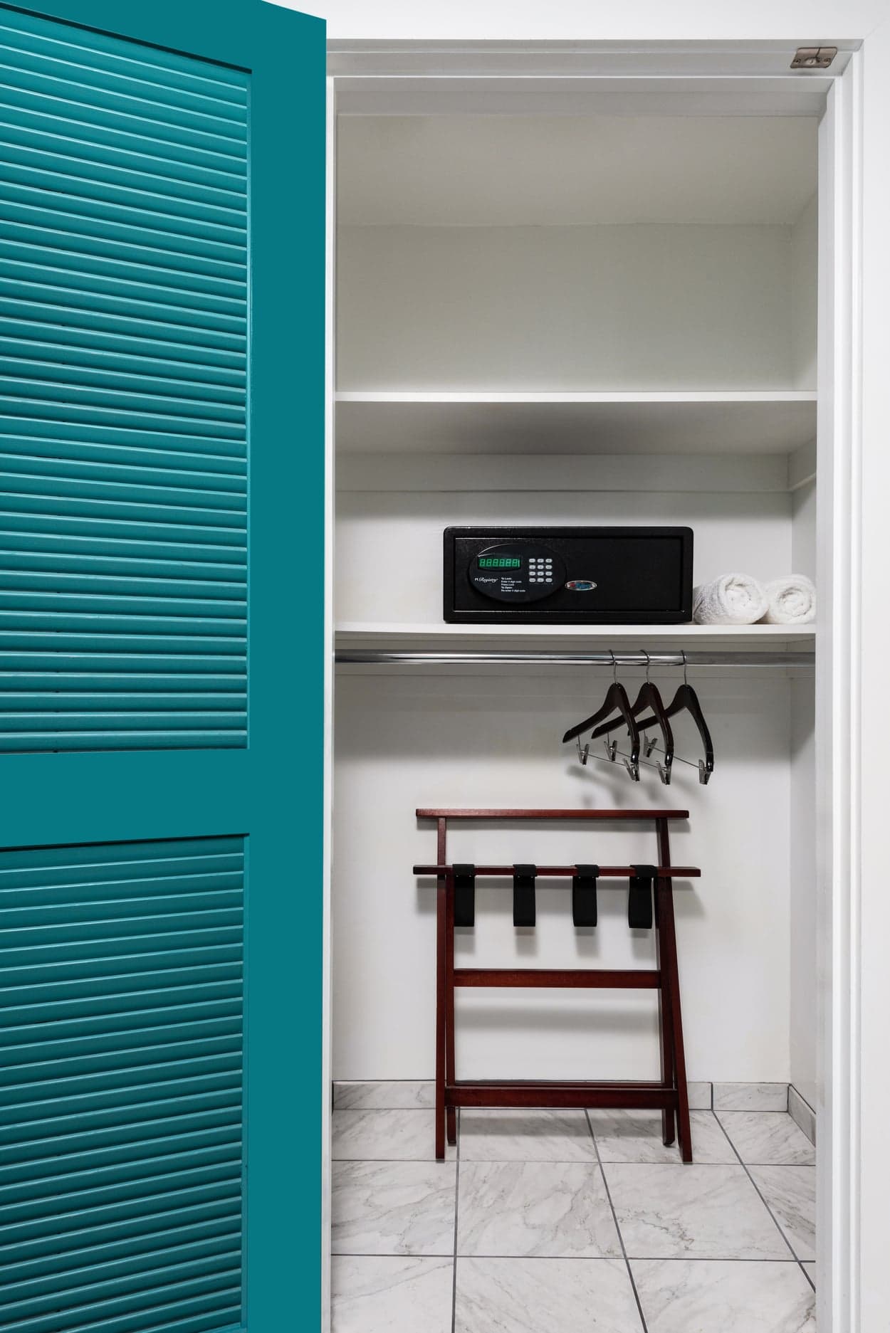 A closet with a safe and lower clothes hanging par for ADA purposes