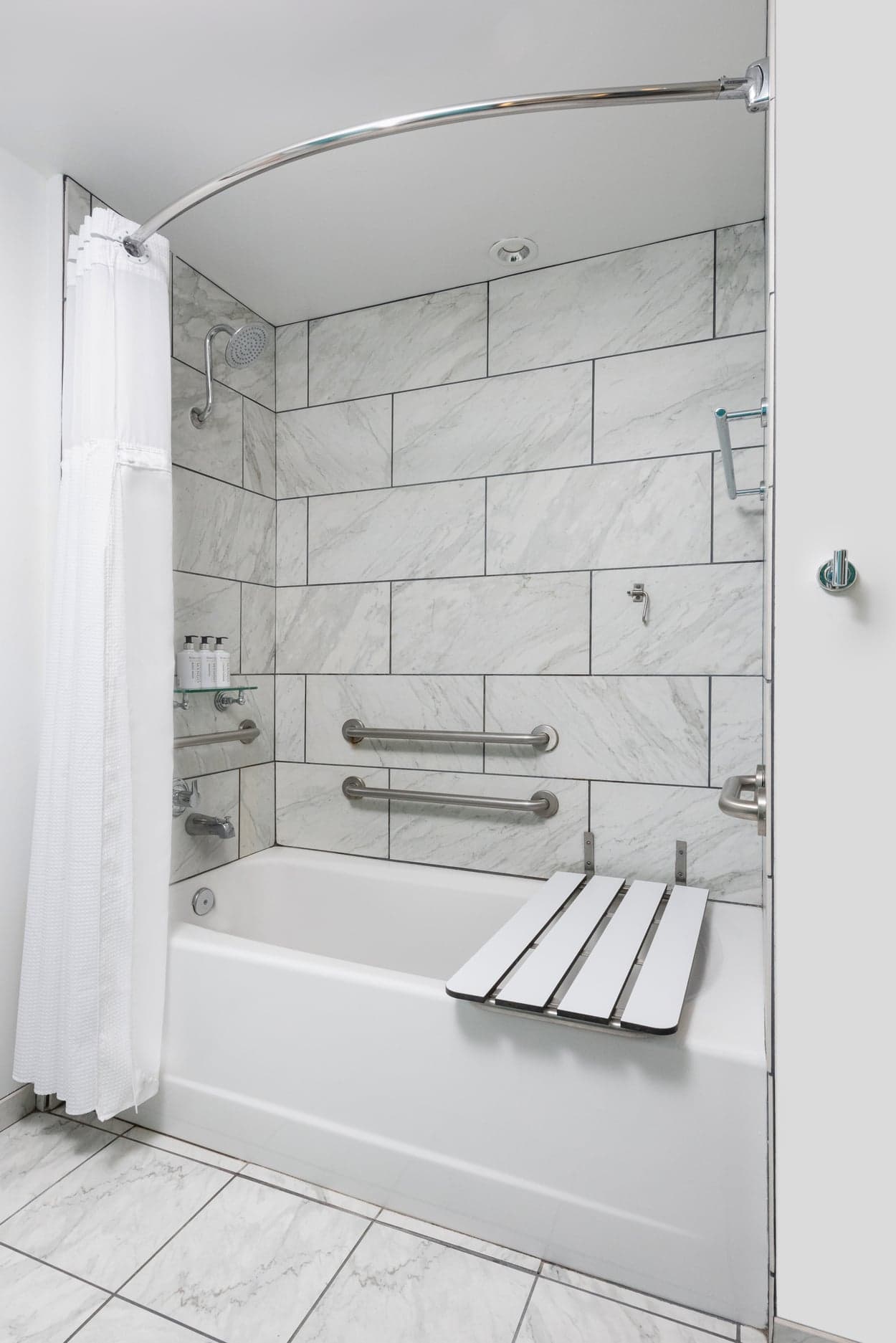 An ADA tub and shower in a room at Kona Kai