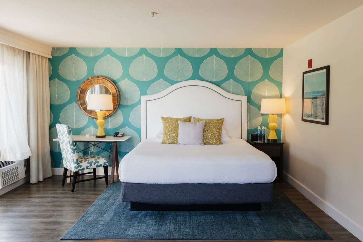 A large ADA room with a king bed and a desk at Kona Kai