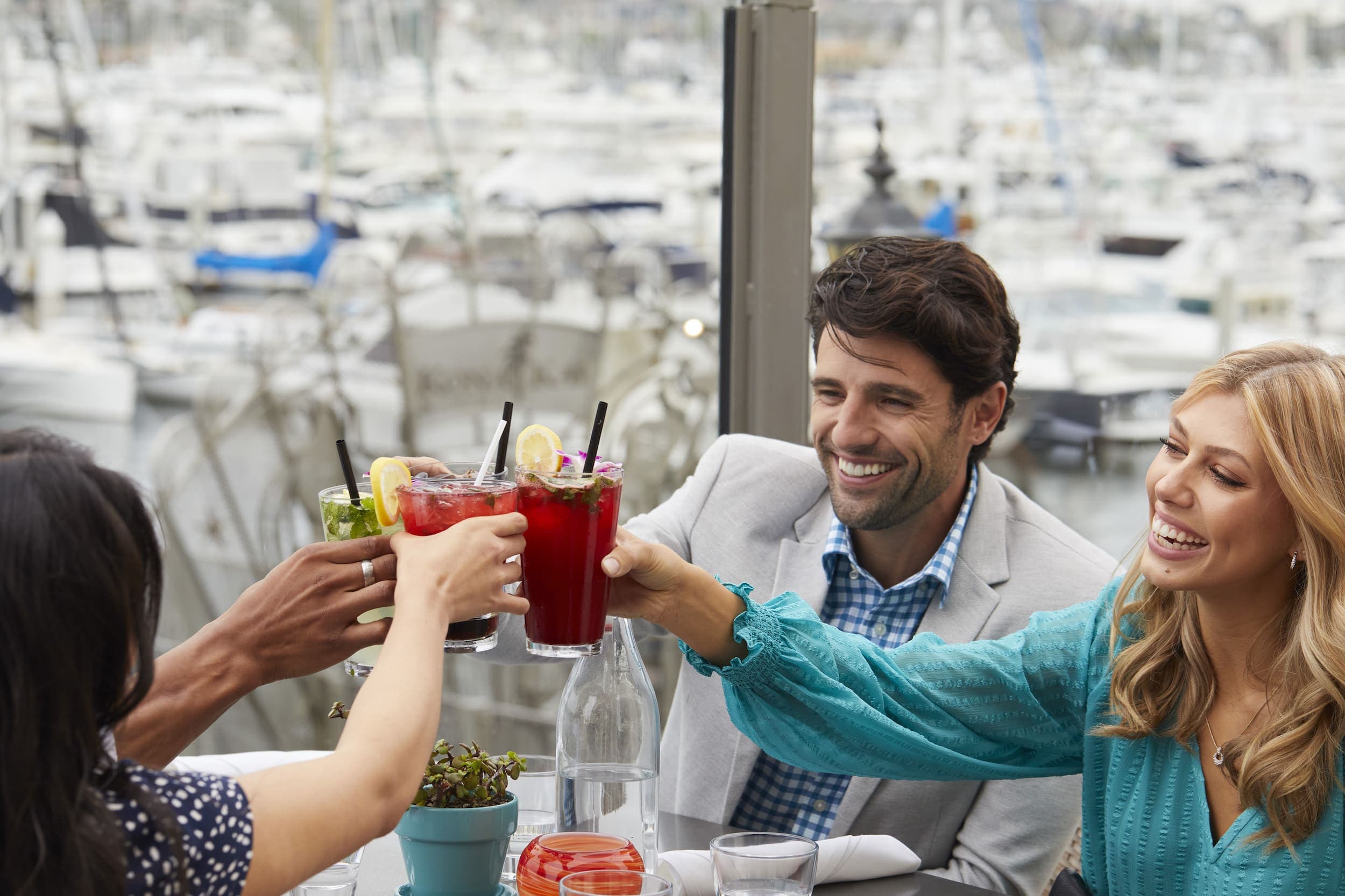 A group a of people drinking cocktails on the patio