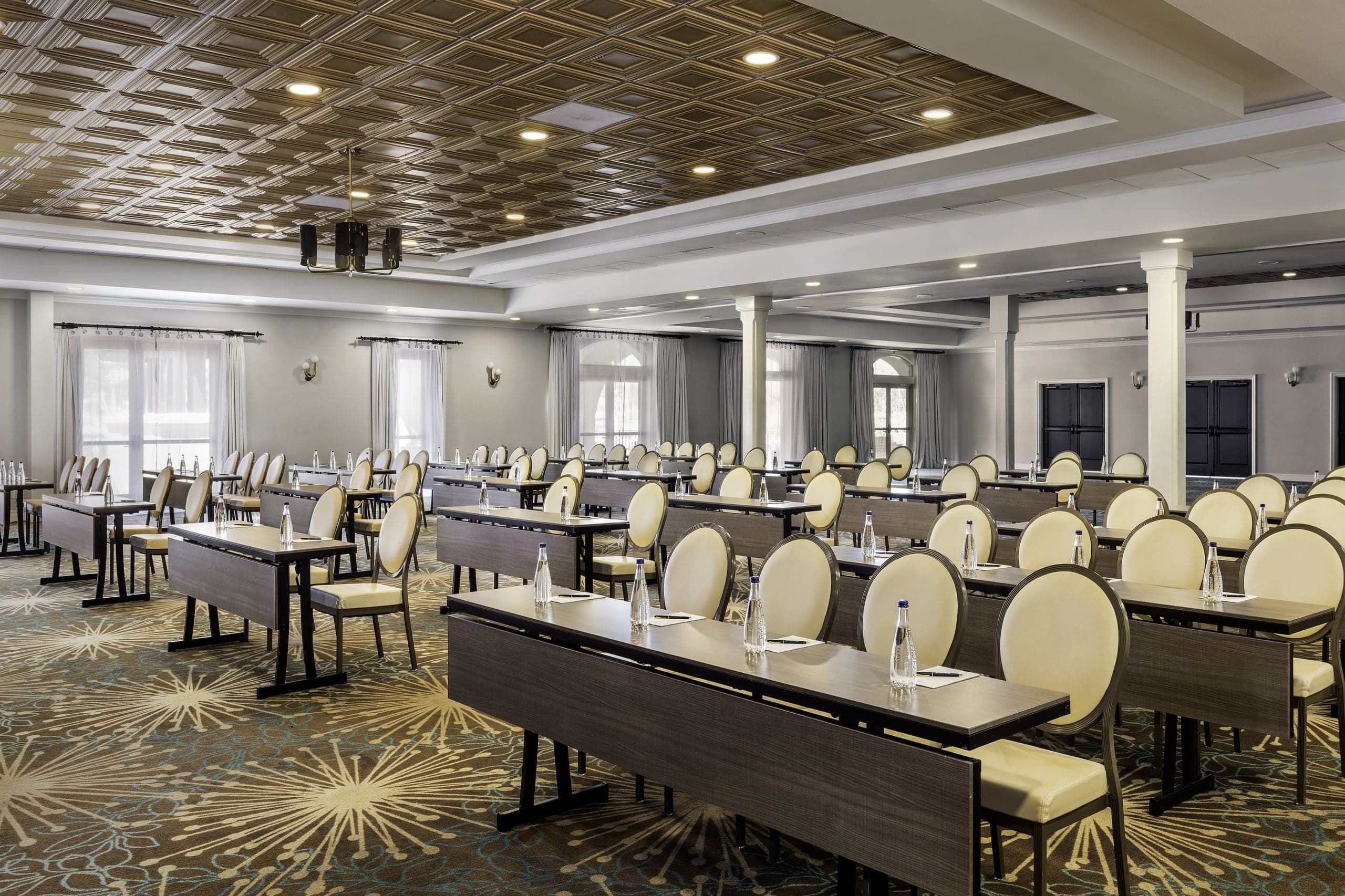 The Point Loma Ballroom set up for a conference, with rows of long tables and chairs pointed at a stage