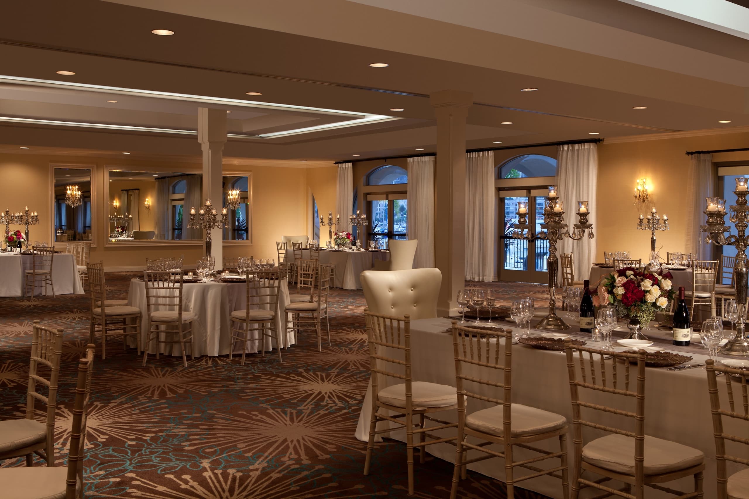 The Point Loma Ballroom set up for a banquet, with round tables topped with white table cloths