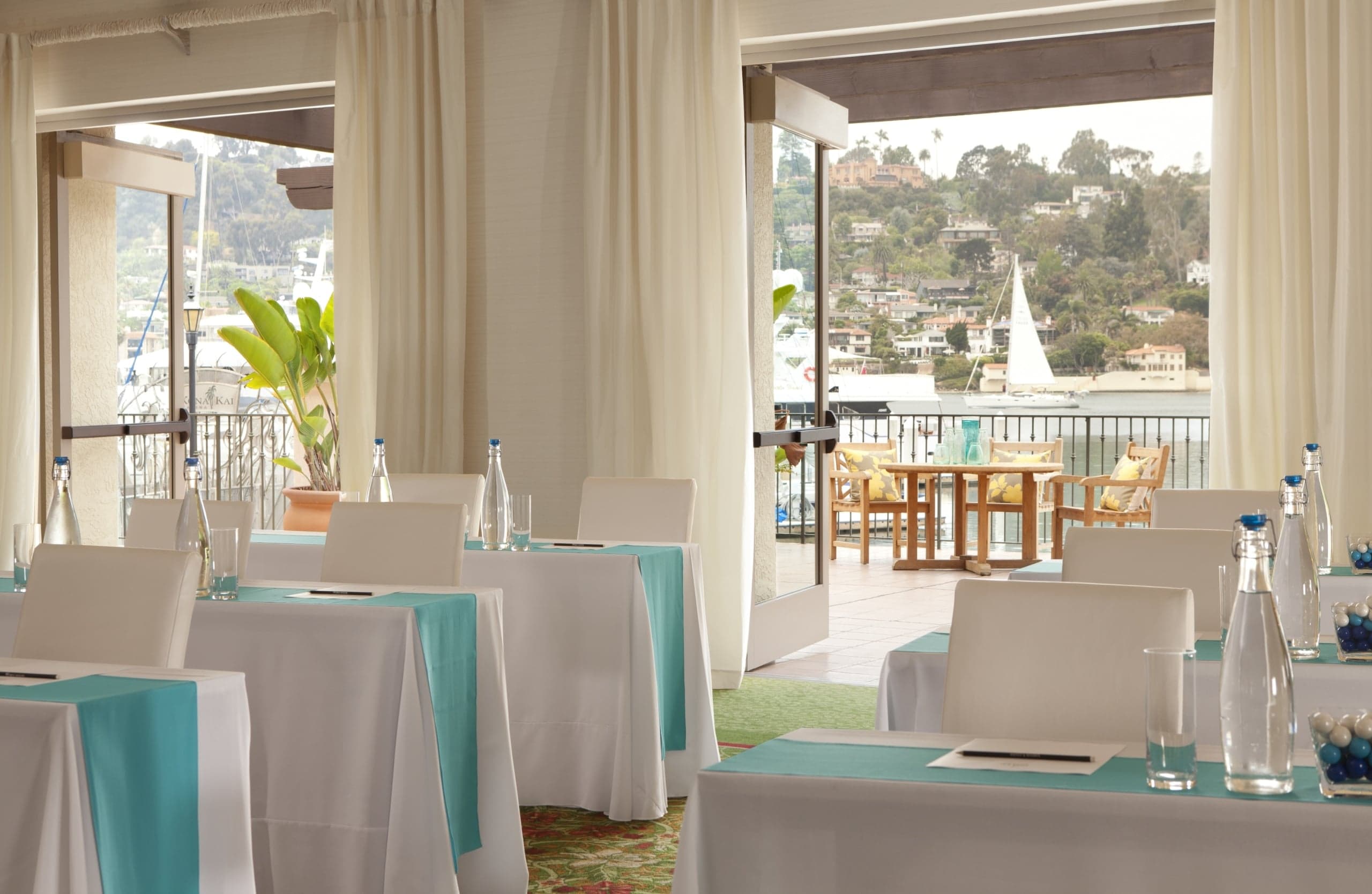 The Point Loma Ballroom set up for a banquet, with airy open windows opening onto the bay