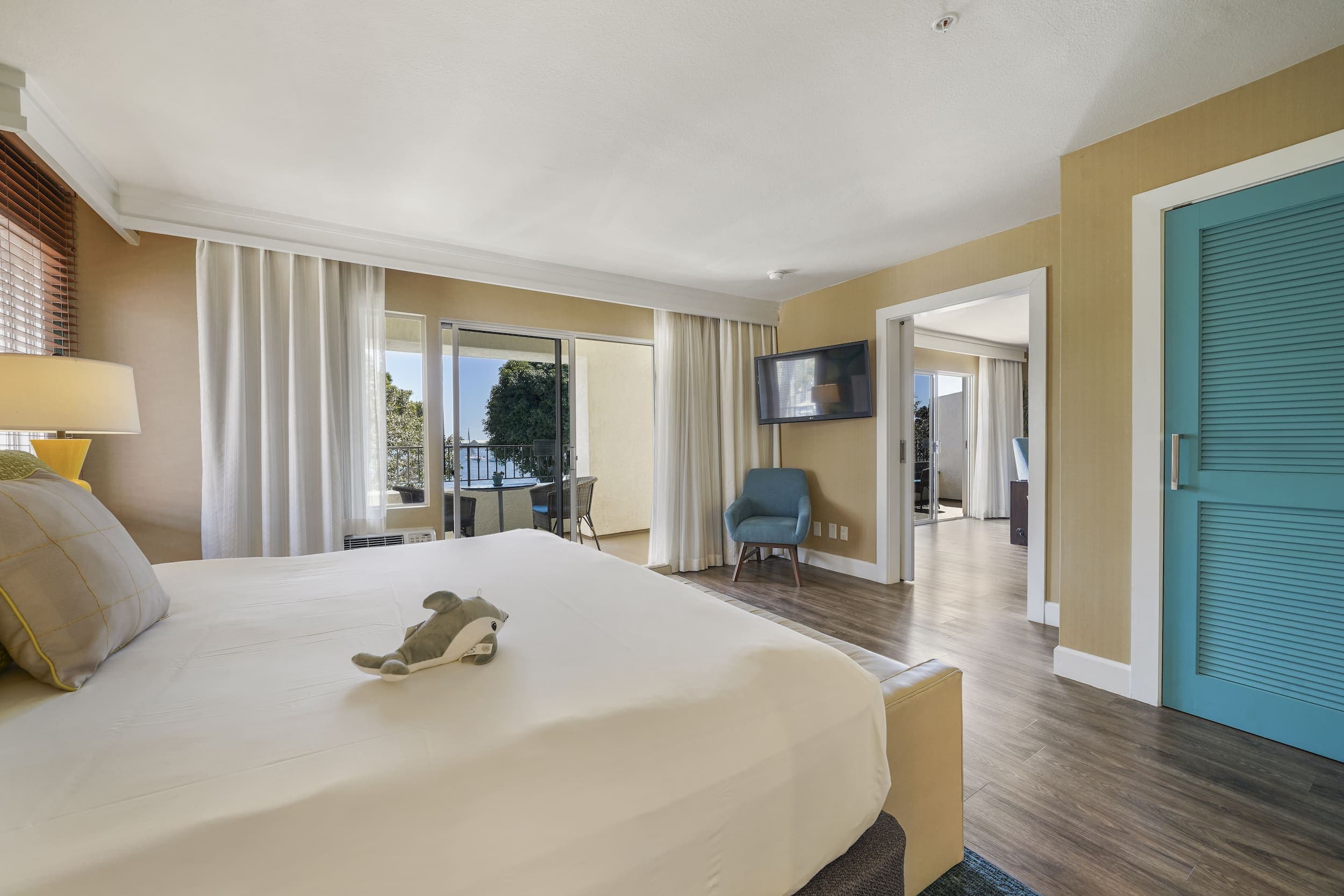 A One Bedroom Suite with a stuffed shark on a king bed at Kona Kai
