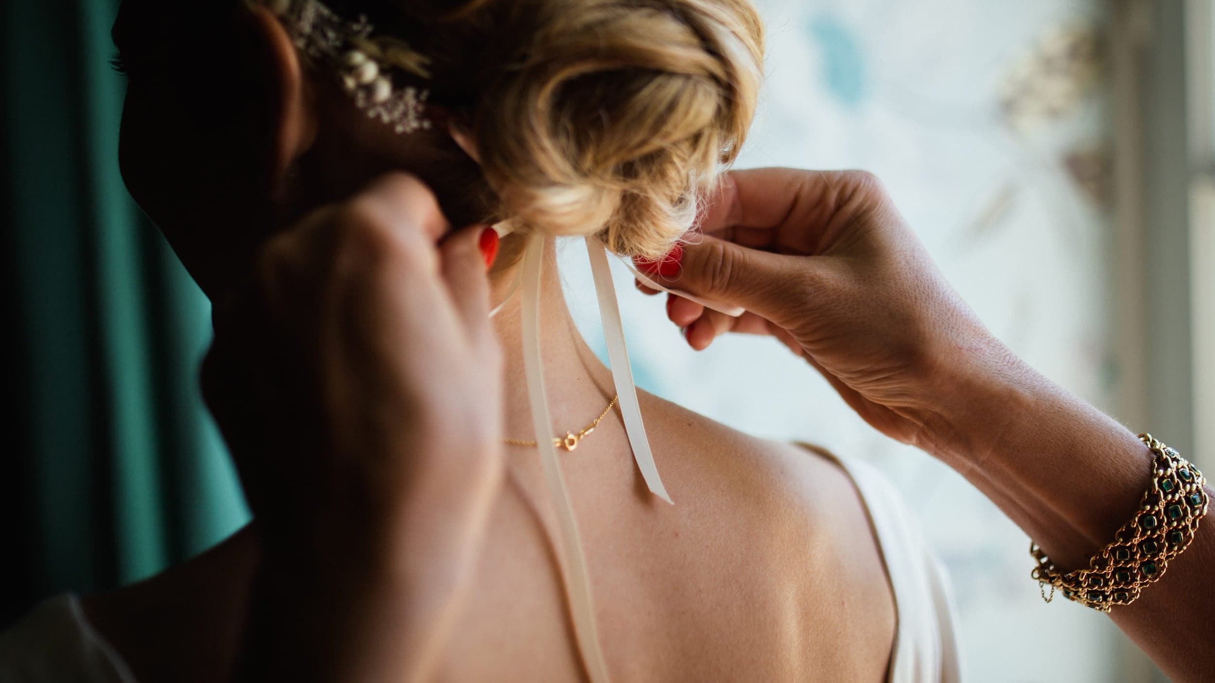 A woman having a bow tied in the back of her hair