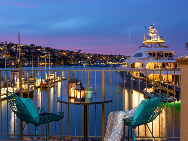 Balcony of luxury hotel suite with view of marina at night in San Diego