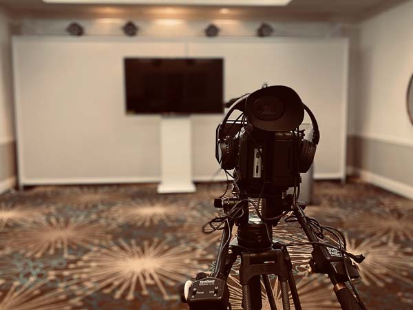 Video recorder set up in a meeting room.