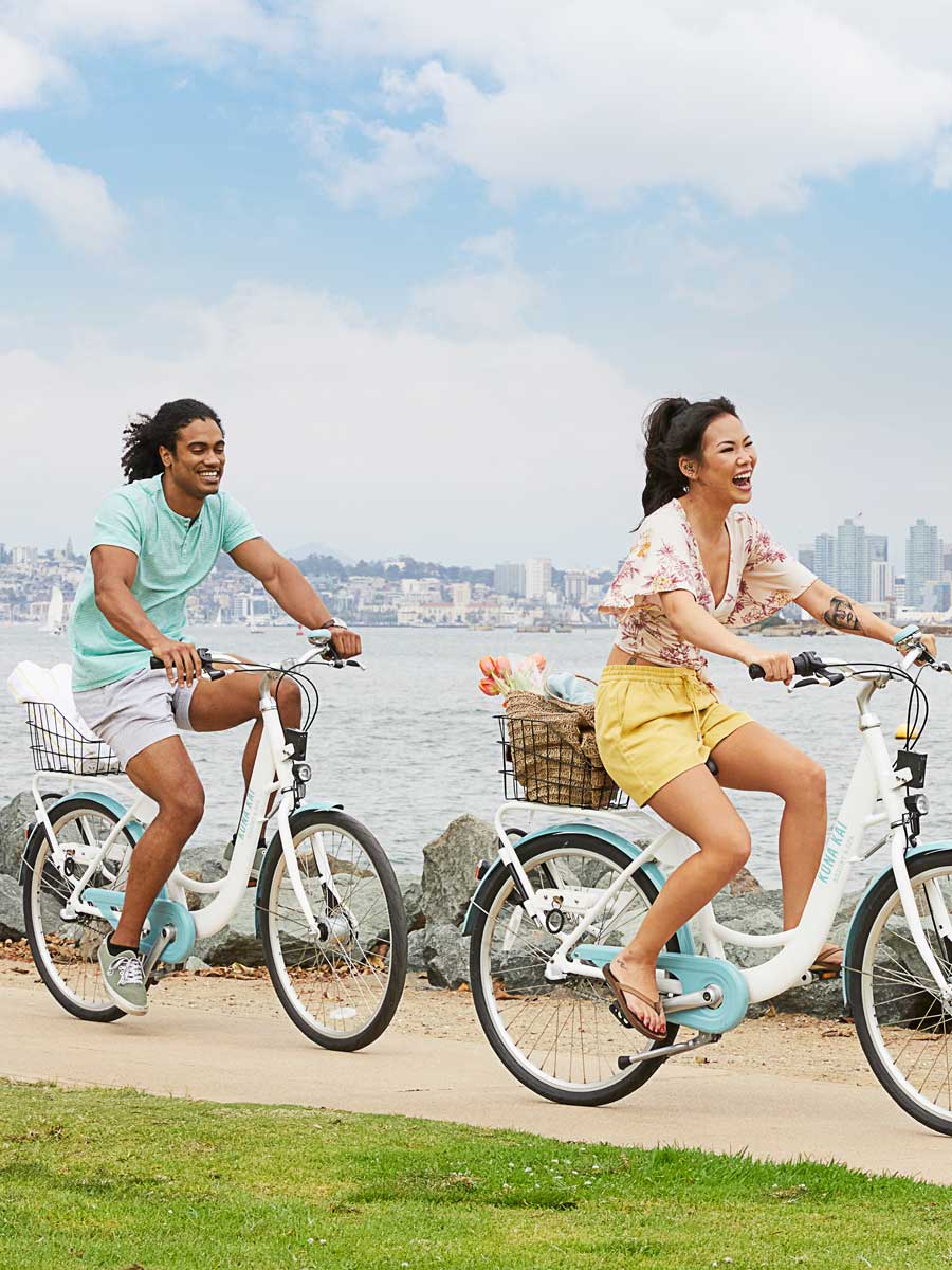 Couple Riding Bikes On The Beach.