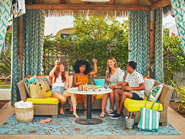 Group Of People Eating and drinking in a cabana.