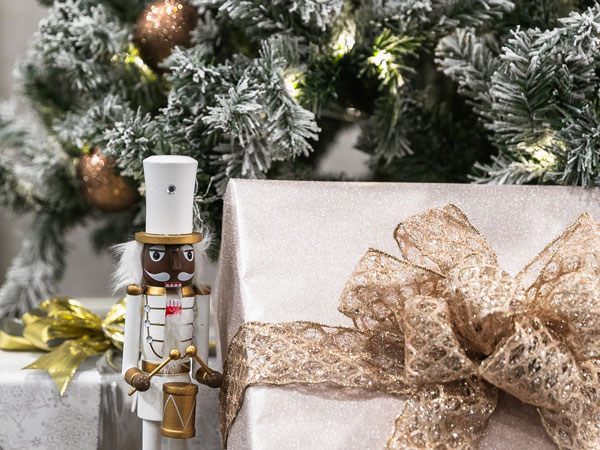 Gift And Nutcracker Under Christmas Tree